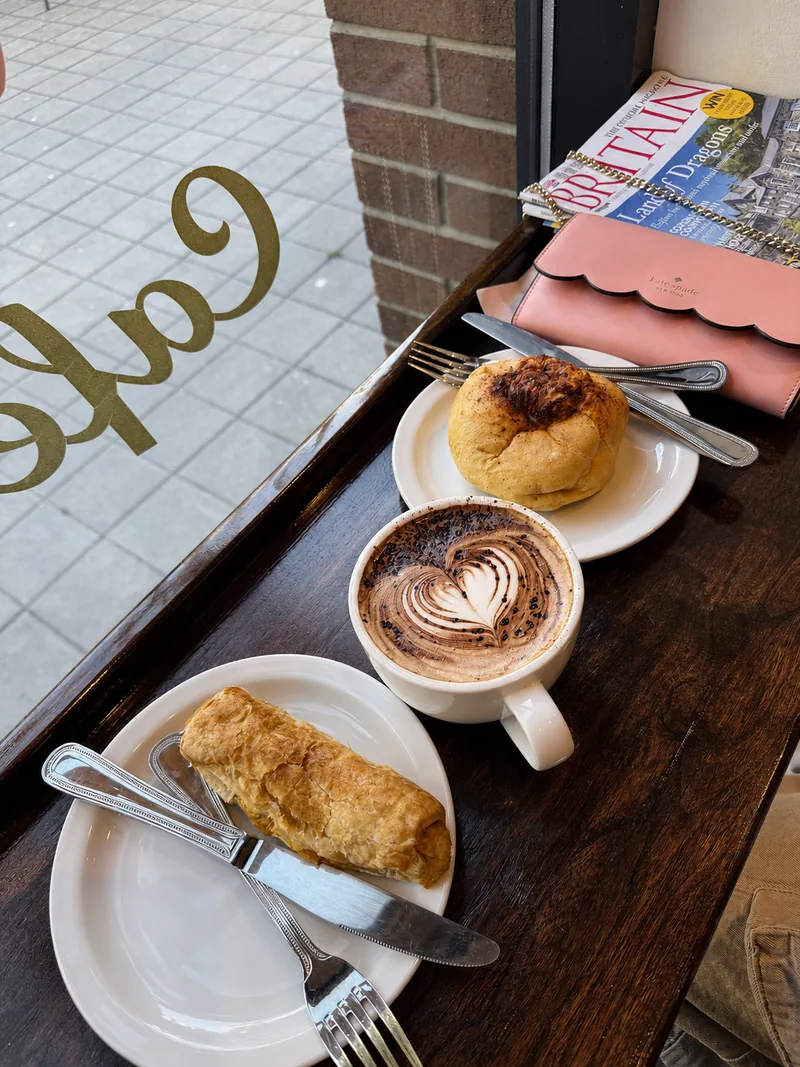 Coffee and baked pastries on the café window counter