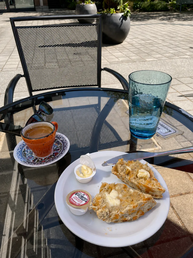 Tea and a scone served at an outdoor patio table
